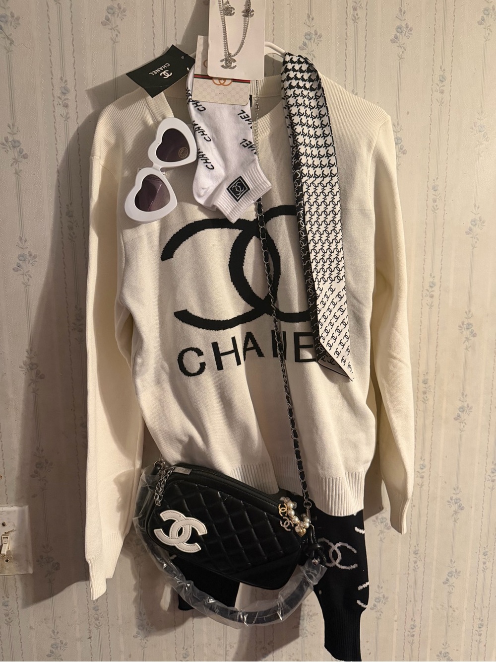 Sweater outfit with logos and accessories